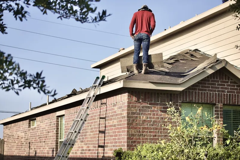 Professional roofer working on a residential roof in Fairfield Plantation